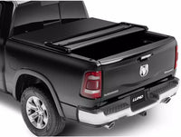 Tri-fold soft tonneau cover for Ram 1500 Laramie by Lund Motion Products Inc, shown installed on truck bed.