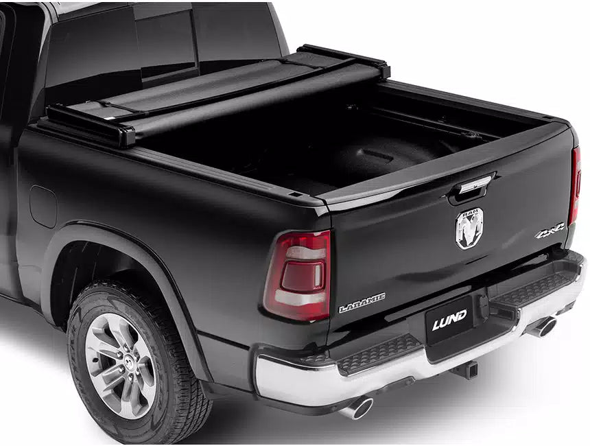Tri Fold soft tonneau cover for Ram 1500 Laramie by Lund Motion Products Inc, shown folded on the truck bed.