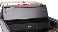 Black BAKFlip G2 tonneau cover installed on RAM 1500, 2500, and 3500 trucks, showing its sleek, foldable design for bed protection.