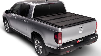 Black BAKFlip G2 tonneau cover on a RAM 1500 Express truck, shown installed on the truck bed for secure cargo protection.