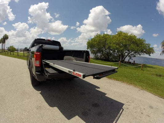 BedSlide S RAM 1500 5'7" AXS bed slide with Ram Boxes installed in a pickup truck bed, showing its sleek design and sturdy construction.
