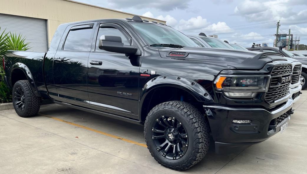 LUND Motion Products Inc. DJ 2020 Bushwacker Flares POCKET for 2500/3500 trucks, showing textured black flare with mounting details.