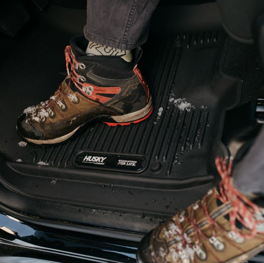 HUSKY LINERS X-ACT AXS floor liners for Dodge Ram 3500 Crew Cab 2019+ in black, featuring durable rubber material and custom fit.