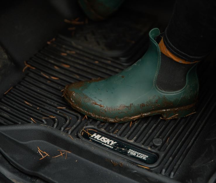 Husky Liners X-ACT floor mats for Dodge Ram 1500 Quad Cab, durable all-weather protection, black rubber with textured surface.